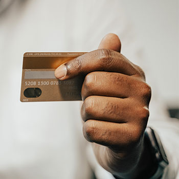 Person Holding Brown Credit Card