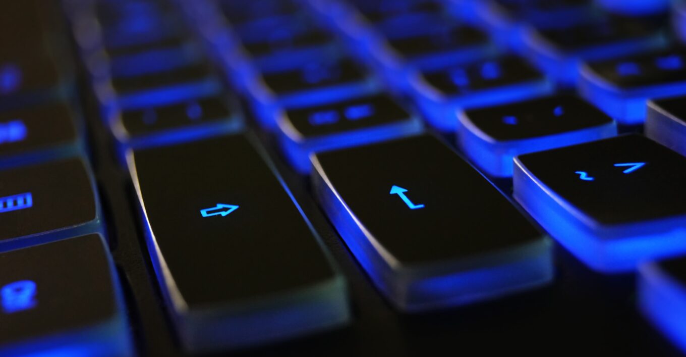 Black keyboard illuminate blue under the Return and Shift keys