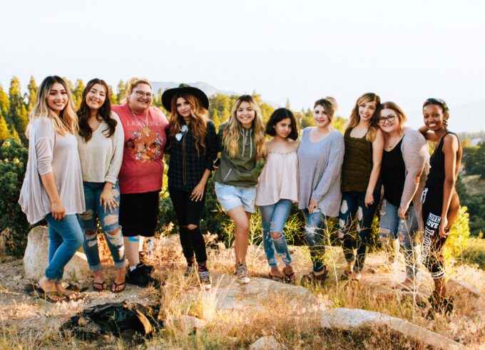 A group of women posing with their arms around each other